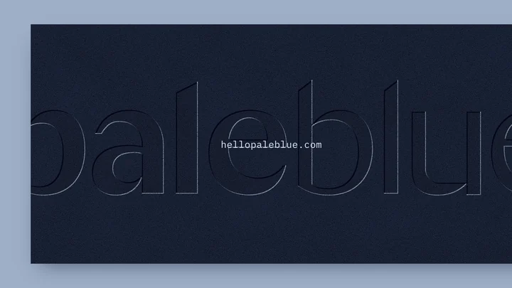 A dark navy card with the Pale Blue wordmark pressed into the paper, running off both edges, and hellopaleblue.com printed small in the center