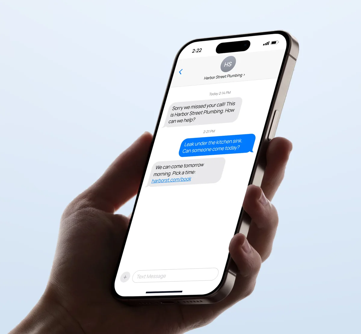 A hand holding a phone with a text conversation: after a missed call, Harbor Street Plumbing texts back, the customer describes a leak, and gets a link to pick a time.